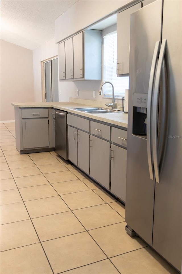 21 Pecan Course Cir, Ocala, FL 34472 - kitchen featuring stainless steel appliances, gray cabinetry, a sink, a peninsula, and light countertops