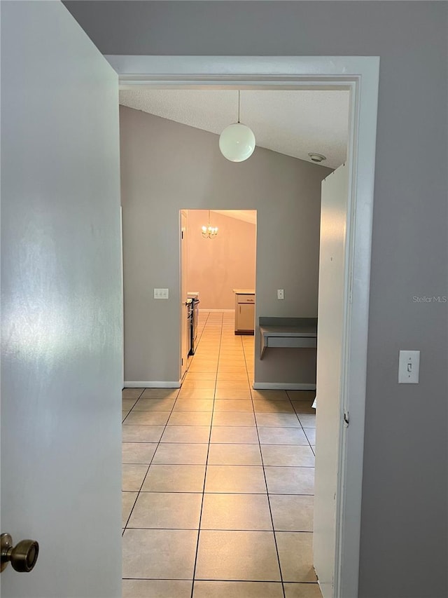 21 Pecan Course Cir, Ocala, FL 34472 - hallway with a chandelier, light tile patterned flooring, lofted ceiling, and baseboards