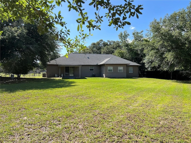 21 Pecan Course Cir, Ocala, FL 34472 - rear view of property featuring a lawn and stucco siding