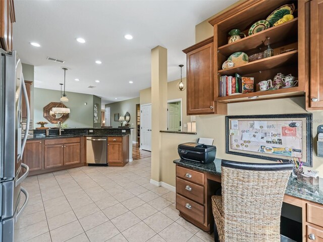 8447 SW 82nd Loop, Ocala, FL 34481 - kitchen featuring dishwasher, brown cabinets, light tile patterned floors, open shelves, and decorative light fixtures