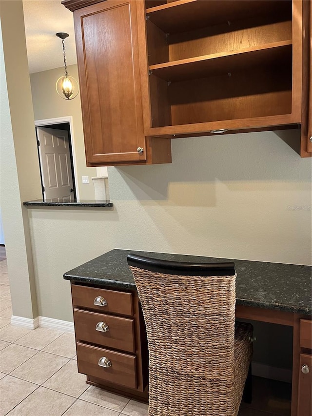 8447 SW 82nd Loop, Ocala, FL 34481 - kitchen with open shelves, light tile patterned floors, dark stone counters, and hanging light fixtures