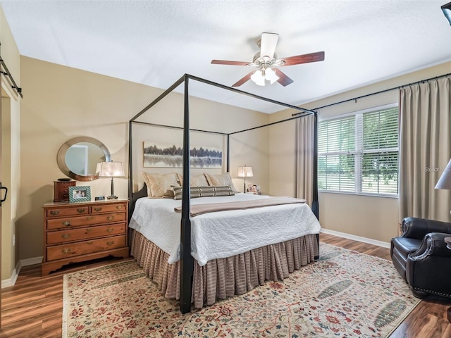 8447 SW 82nd Loop, Ocala, FL 34481 - bedroom featuring wood finished floors, baseboards, and a ceiling fan