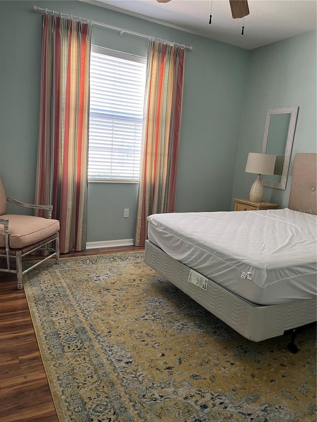 8447 SW 82nd Loop, Ocala, FL 34481 - bedroom featuring dark wood-style floors, baseboards, and a ceiling fan