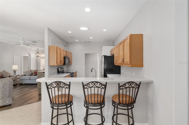 1748 SW 157th Place Rd, Ocala, FL 34473 - kitchen with appliances with stainless steel finishes, open floor plan, light countertops, ceiling fan, and recessed lighting