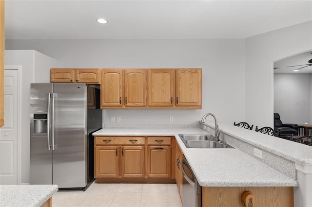 1748 SW 157th Place Rd, Ocala, FL 34473 - kitchen with appliances with stainless steel finishes, a sink, a peninsula, light tile patterned floors, and a ceiling fan
