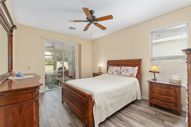 1748 SW 157th Place Rd, Ocala, FL 34473 - bedroom featuring access to exterior, wood finished floors, ceiling fan, and baseboards