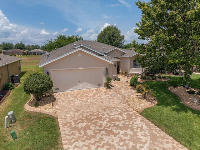 1748 SW 157th Place Rd, Ocala, FL 34473 - ranch-style home featuring decorative driveway, a garage, a front yard, cooling unit, and stucco siding