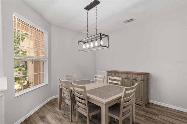 1748 SW 157th Place Rd, Ocala, FL 34473 - dining room with wood finished floors, baseboards, and a chandelier