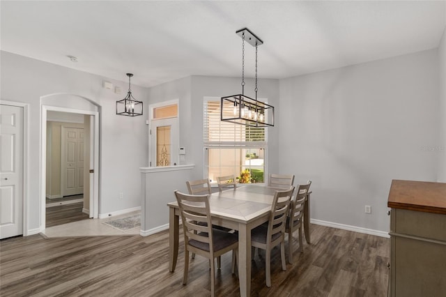 1748 SW 157th Place Rd, Ocala, FL 34473 - dining room with a chandelier, wood finished floors, and baseboards