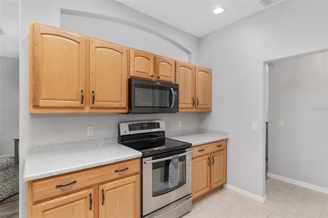 1748 SW 157th Place Rd, Ocala, FL 34473 - kitchen featuring black microwave, electric range, light countertops, light tile patterned flooring, and recessed lighting
