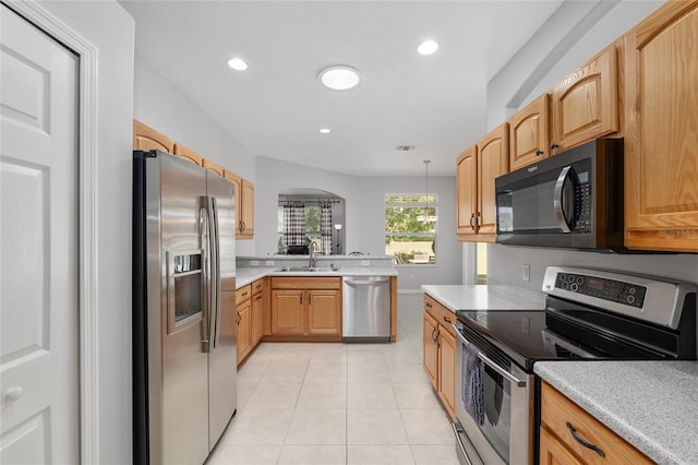 1748 SW 157th Place Rd, Ocala, FL 34473 - kitchen featuring stainless steel appliances, light countertops, light tile patterned flooring, arched walkways, and recessed lighting