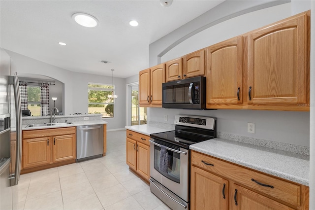 1748 SW 157th Place Rd, Ocala, FL 34473 - kitchen featuring stainless steel appliances, a sink, light countertops, light tile patterned flooring, and recessed lighting
