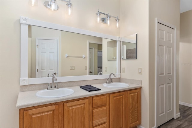 1748 SW 157th Place Rd, Ocala, FL 34473 - full bathroom featuring double vanity, wood finished floors, and baseboards