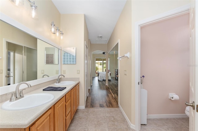1748 SW 157th Place Rd, Ocala, FL 34473 - ensuite bathroom featuring toilet, double vanity, tile patterned floors, and ceiling fan
