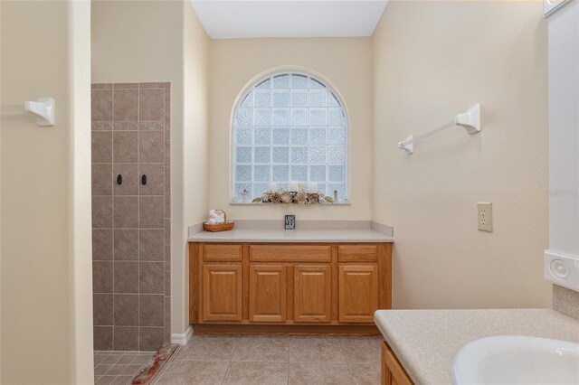 1748 SW 157th Place Rd, Ocala, FL 34473 - bathroom featuring tiled shower, vanity, and tile patterned floors