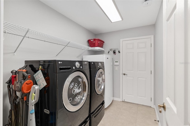 1748 SW 157th Place Rd, Ocala, FL 34473 - washroom with washer and clothes dryer and light tile patterned floors
