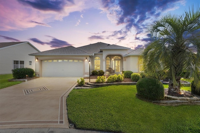 3141 Roswell Rd, The Villages, FL 32162 - view of front facade with stucco siding, driveway, an attached garage, and a front lawn