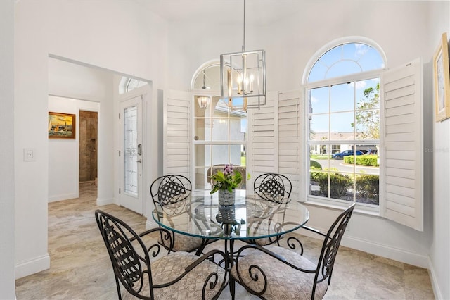 3141 Roswell Rd, The Villages, FL 32162 - dining area featuring a towering ceiling, baseboards, and a chandelier