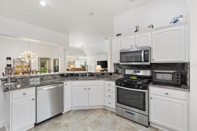 3141 Roswell Rd, The Villages, FL 32162 - kitchen with stainless steel appliances, a sink, decorative columns, decorative backsplash, and white cabinets