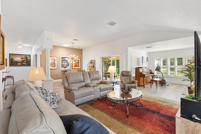 3141 Roswell Rd, The Villages, FL 32162 - living area featuring light wood-style flooring, decorative columns, a chandelier, and lofted ceiling