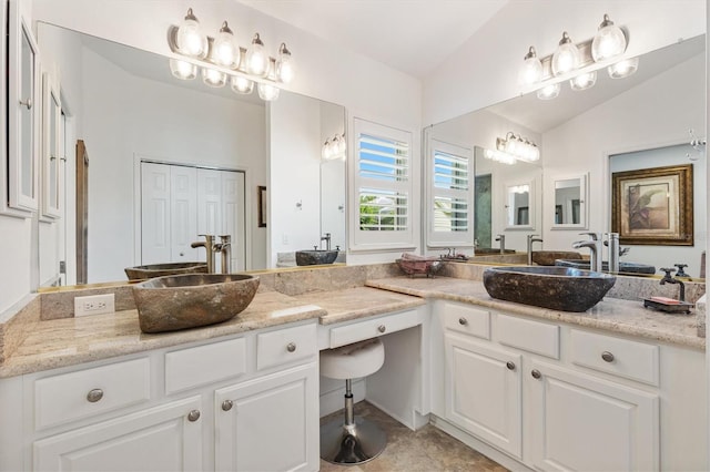 3141 Roswell Rd, The Villages, FL 32162 - full bath with double vanity, vaulted ceiling, and a closet