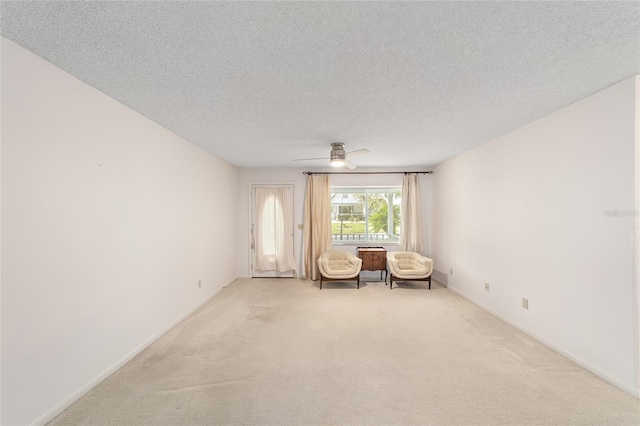 8885 SW 90th Ave, Ocala, FL 34481 - sitting room featuring carpet flooring, a ceiling fan, a textured ceiling, and baseboards