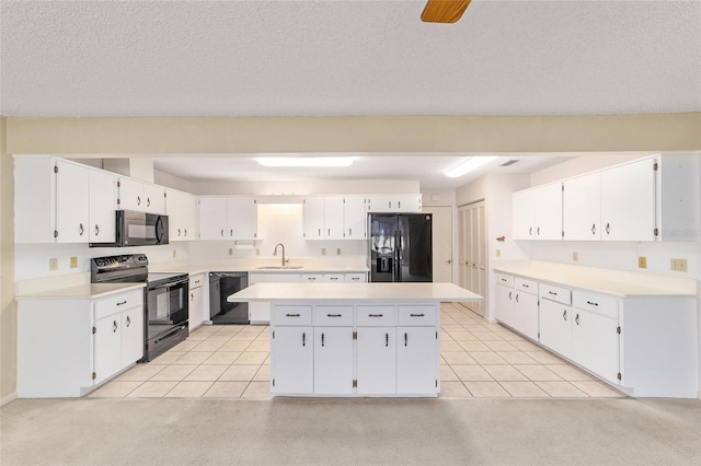 8885 SW 90th Ave, Ocala, FL 34481 - kitchen with black appliances, a sink, a center island, and white cabinetry