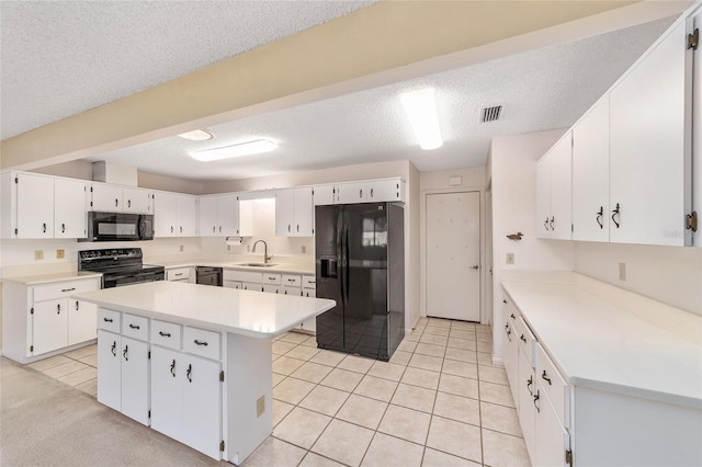 8885 SW 90th Ave, Ocala, FL 34481 - kitchen featuring black appliances, a sink, light tile patterned flooring, white cabinetry, and a textured ceiling