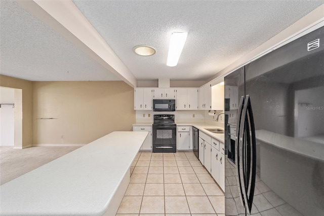 8885 SW 90th Ave, Ocala, FL 34481 - kitchen featuring black appliances, a textured ceiling, a sink, light countertops, and white cabinets
