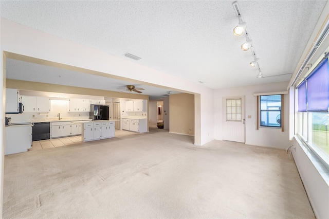 8885 SW 90th Ave, Ocala, FL 34481 - unfurnished living room featuring light colored carpet, a sink, a ceiling fan, baseboards, and rail lighting