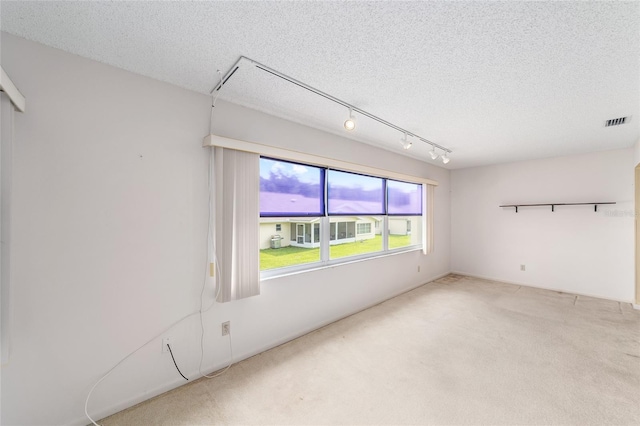 8885 SW 90th Ave, Ocala, FL 34481 - carpeted spare room with attic access, a textured ceiling, and rail lighting