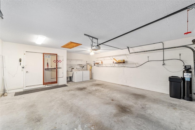 8885 SW 90th Ave, Ocala, FL 34481 - garage with washing machine and clothes dryer, a garage door opener, and a sink