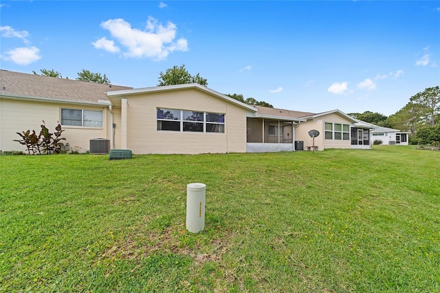 8885 SW 90th Ave, Ocala, FL 34481 - rear view of property featuring a sunroom, a yard, and central air condition unit