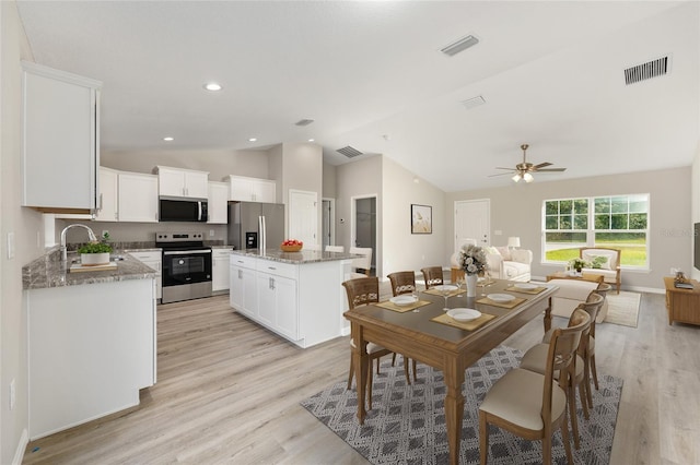 10158 N Carib Way, Citrus Springs, FL 34434 - dining space with vaulted ceiling, ceiling fan, and light wood-type flooring