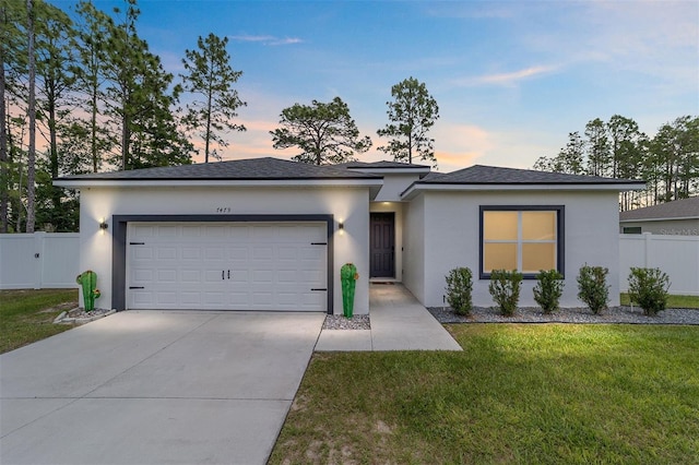 7479 SW 130th Ln, Ocala, FL 34473 - view of front facade with an attached garage, concrete driveway, and stucco siding
