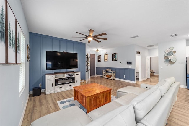7479 SW 130th Ln, Ocala, FL 34473 - living room featuring ceiling fan, light wood-style flooring, and baseboards