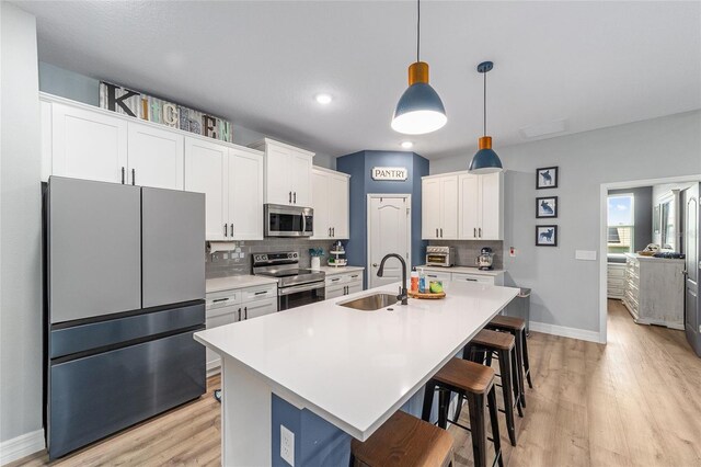 7479 SW 130th Ln, Ocala, FL 34473 - kitchen featuring appliances with stainless steel finishes, a sink, baseboards, decorative backsplash, and recessed lighting