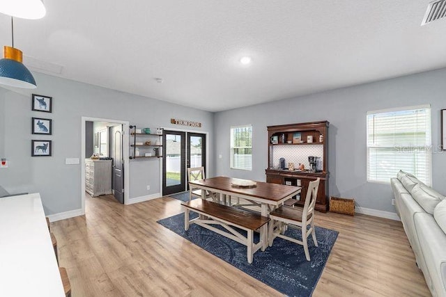 7479 SW 130th Ln, Ocala, FL 34473 - dining room with baseboards, light wood-style flooring, and french doors