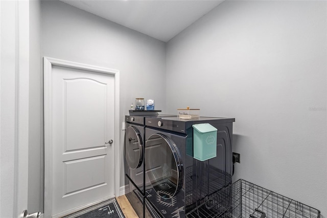 7479 SW 130th Ln, Ocala, FL 34473 - laundry room with washing machine and clothes dryer and light wood-style flooring