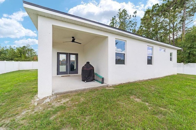 7479 SW 130th Ln, Ocala, FL 34473 - rear view of house with a ceiling fan, a patio, and stucco siding