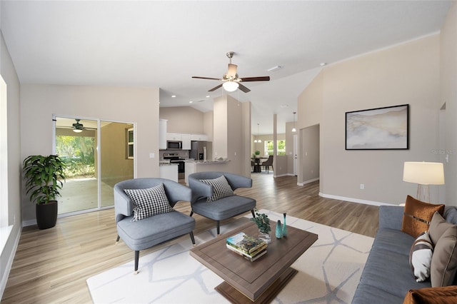 12505 SW 73rd St, Ocala, FL 34481 - living room with a ceiling fan, plenty of natural light, light wood finished floors, baseboards, and high vaulted ceiling