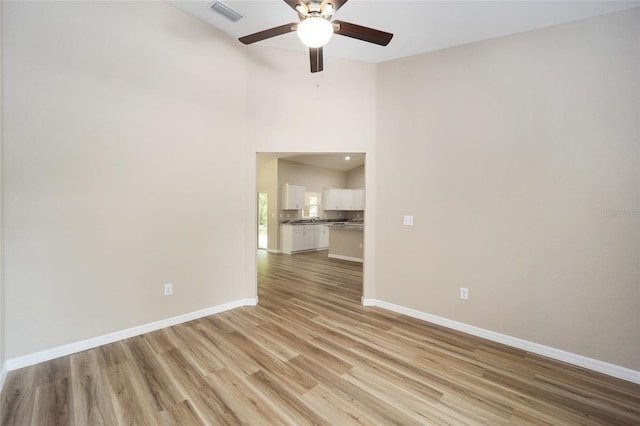 12505 SW 73rd St, Ocala, FL 34481 - spare room with a ceiling fan, light wood-style floors, baseboards, and a high ceiling