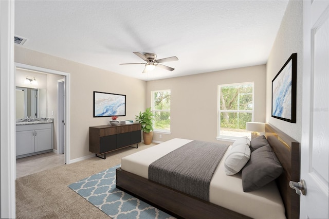 12505 SW 73rd St, Ocala, FL 34481 - bedroom featuring light colored carpet, a sink, ensuite bath, baseboards, and ceiling fan
