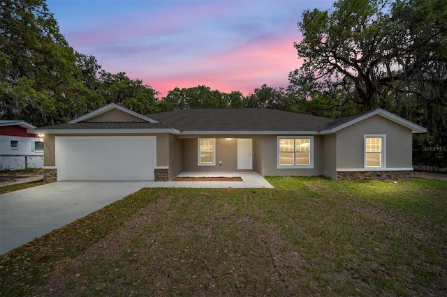 12505 SW 73rd St, Ocala, FL 34481 - single story home featuring stone siding, stucco siding, an attached garage, concrete driveway, and a lawn