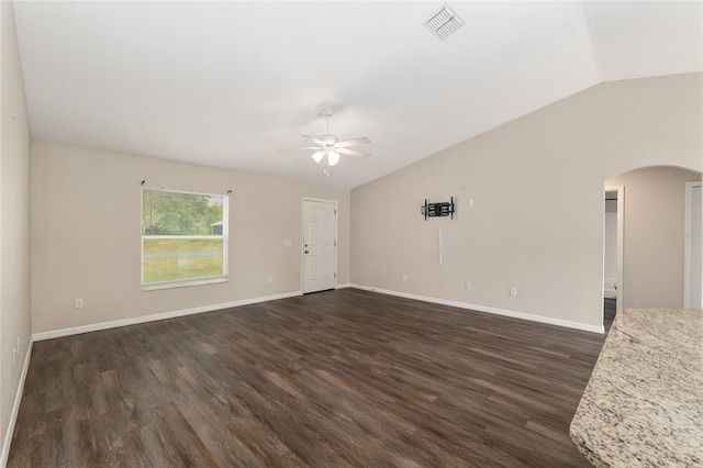 6561 SW 129th Loop, Ocala, FL 34473 - empty room featuring vaulted ceiling, arched walkways, ceiling fan, dark wood-style flooring, and baseboards