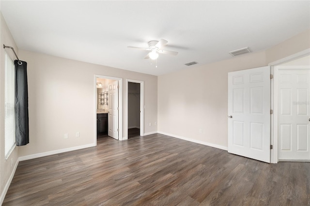 6561 SW 129th Loop, Ocala, FL 34473 - unfurnished bedroom featuring dark wood finished floors, baseboards, a walk in closet, and a ceiling fan
