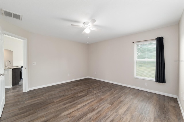 6561 SW 129th Loop, Ocala, FL 34473 - unfurnished room with a ceiling fan, dark wood-style flooring, baseboards, and a sink