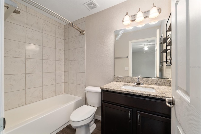 6561 SW 129th Loop, Ocala, FL 34473 - bathroom with toilet, vanity, tub / shower combination, a textured wall, and ceiling fan