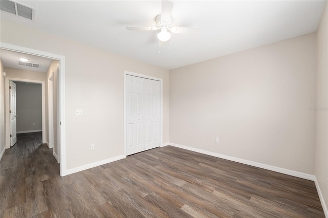 6561 SW 129th Loop, Ocala, FL 34473 - unfurnished bedroom with dark wood-type flooring, baseboards, a closet, and a ceiling fan