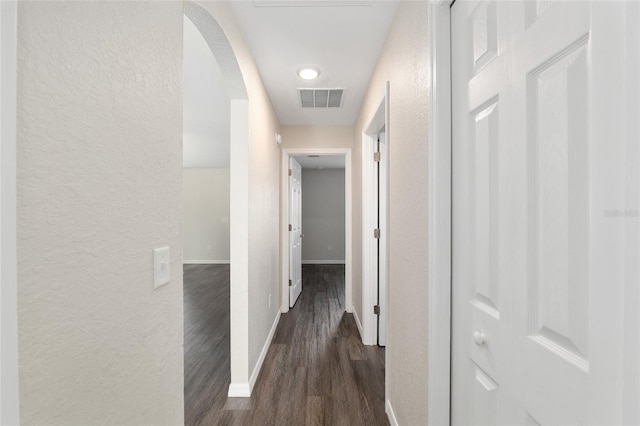 6561 SW 129th Loop, Ocala, FL 34473 - hall with a textured wall, arched walkways, dark wood finished floors, and baseboards